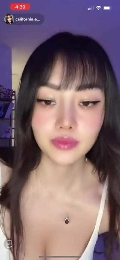 Big titty Chinese chick setting up her live stream bent over cleavage