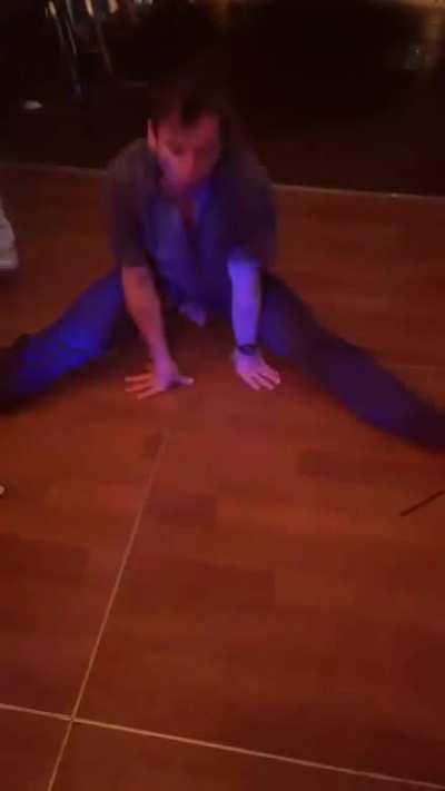 At a wedding doing the splits
