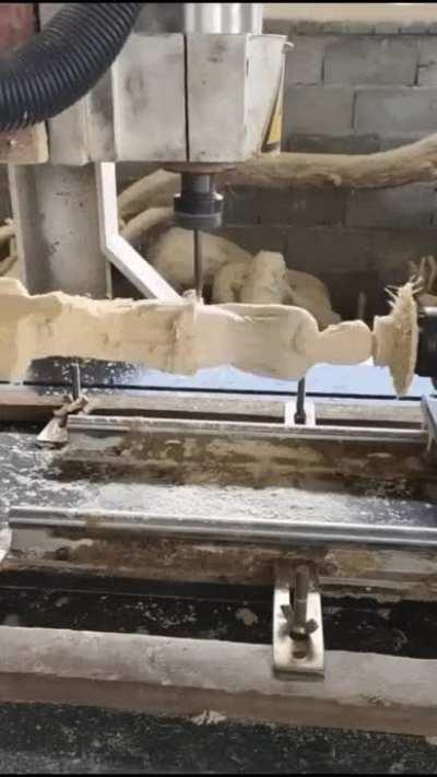CNC milling lathe creating a wood sculpture