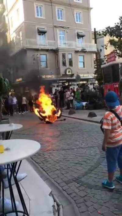 Crazy guy burning himself in the middle of the street
