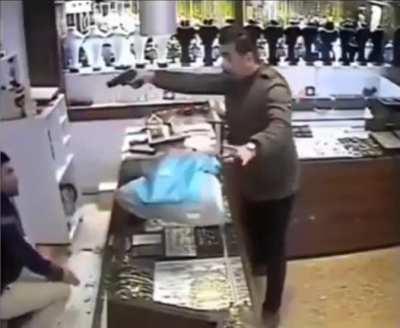 Badass store clerk takes down robber waving gun