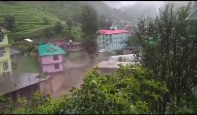 Flash floods wade into a settlement in Himachal, India after heavy rainfall