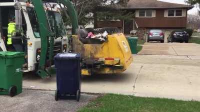 Hydraulic line on a garbage truck bursts and sprays fluid into the exhaust, causing a fireball to erupt. The incident occurred on April 1st, 2020, filmed by a garbage truck enthusiast. No injuries were sustained.