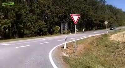 Cyclist not signaling and checking his shoulder during a turn gets hit by a car overtaking at an intersection.