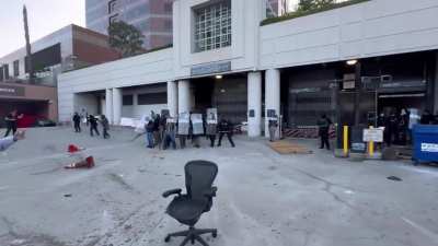 NOW - Police in riot gear use less-than-lethal rounds to disperse protesters gathering around an ICE detention center in Los Angeles following today's raids.