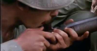American soldiers shotgunning bindles of marijuana in Vietnam.