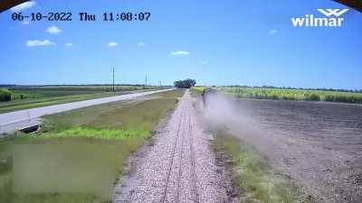 Sugar cane truck cuts in front of sugar cane train