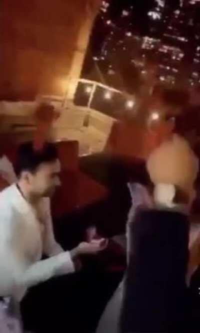 Man proposes to woman after which she grabs her phone to upload a picture on Instagram