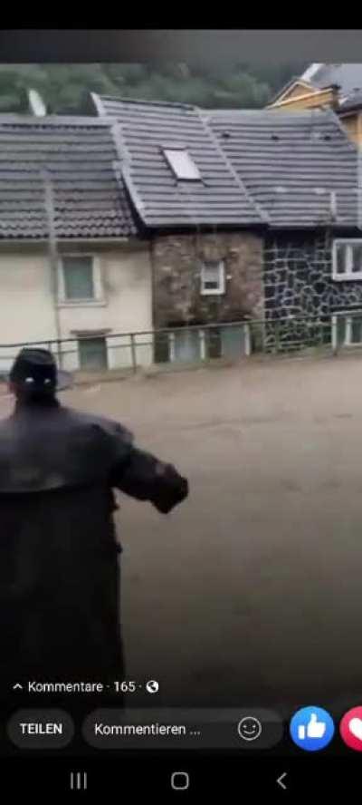 People saving a frieman from drowning during today's flooding catastrophe in Germany