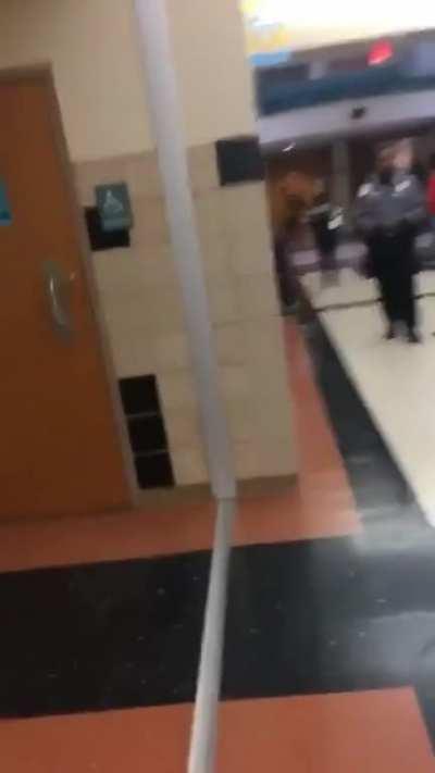 Casually stands next to a growing fire