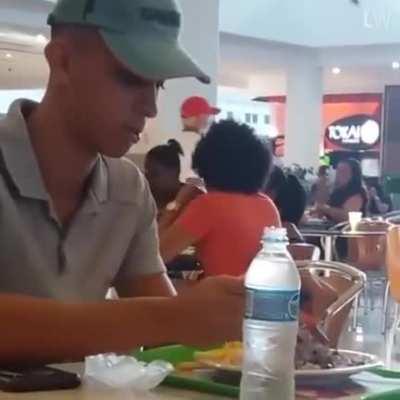 Restaurant worker noticed a disabled man was struggling to eat so he sat down and helped him