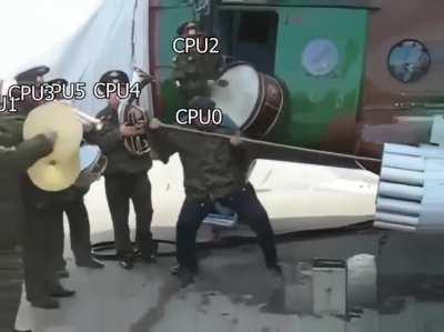 Military men cheering on guy cleaning a gun barrel
