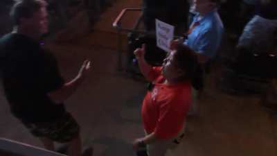 Arena employees (and concertgoers) attempting to convince a drunk patron to dance elsewhere