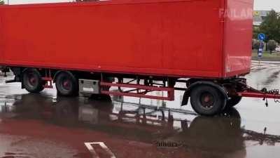 A runaway truck backing across a parking lot