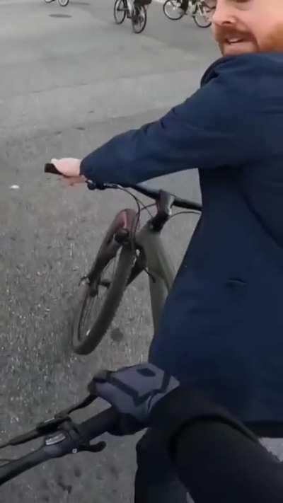 Guy rides his bike onto a woman, doesn't apologies and gets angry when he gets confronted.