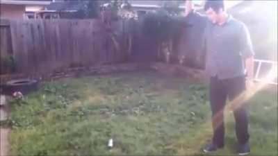 Throwing a knife into a spray paint can