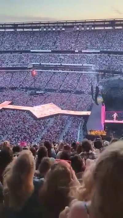 Taylor Swift captivating a massive crowd of 98,000 fans live on stage