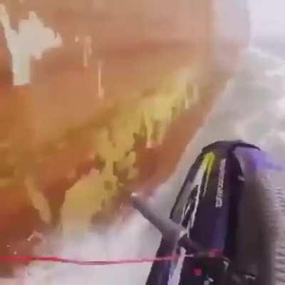 Jet Skier almost gets sucked under huge container ship...