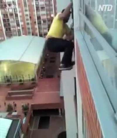dog hanging off a balcony.