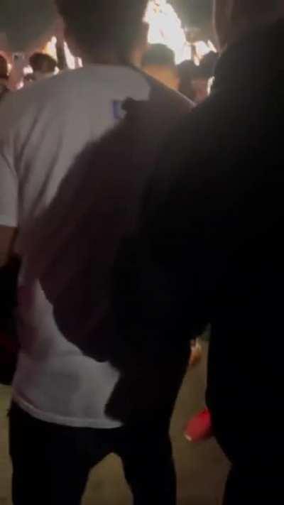 Throwing a bottle at a group of people and provoking them at Astroworld