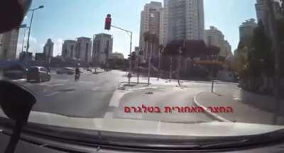 Person on an electric bike almost gets hit by a car after passing 2 red lights