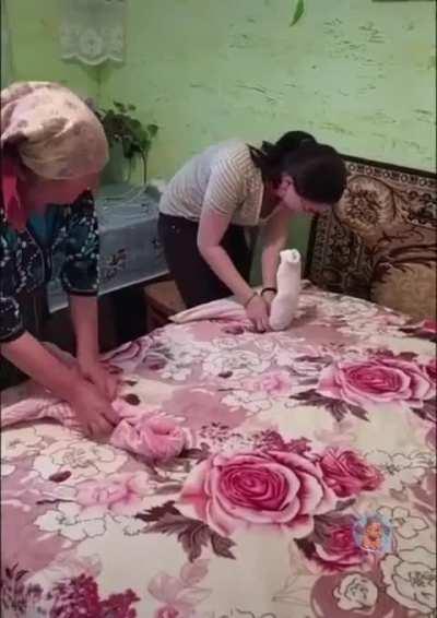 Teaching grandma how to fold a towel