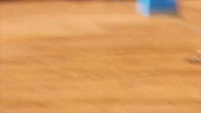 Motocross rider gets his rear wheel stuck in the starting gate.