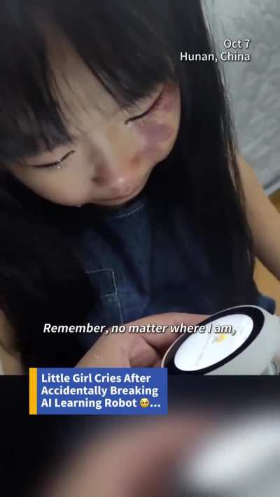 Her AI friend robot is broken and dying. So she's crying.