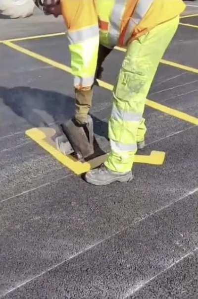 Hot nacho cheese used for parking lot markings