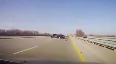 Maybe get off of the highway before you decide to change your tire?