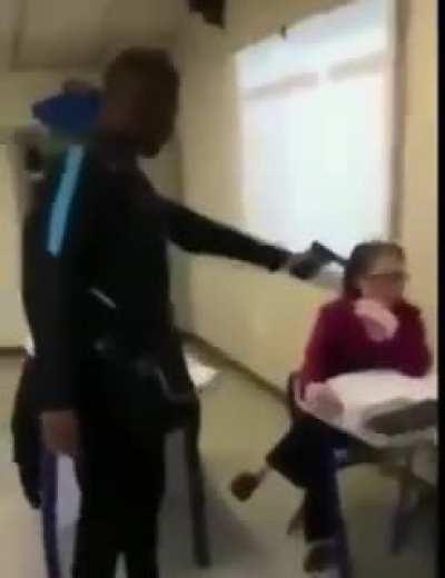 Laughing at a student pointing a gun at a teacher