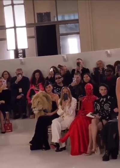 Kylie attends fashion show wearing same severed-lion-head-dress as model. What is this??