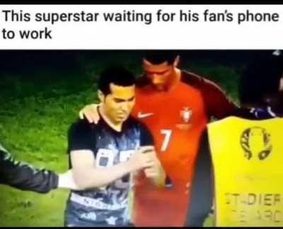 Christian Ronaldo brushes off security as he patiently waits for his nervous fan's phone to work