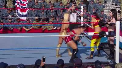 Mandy Rose striking Bayley in the corner