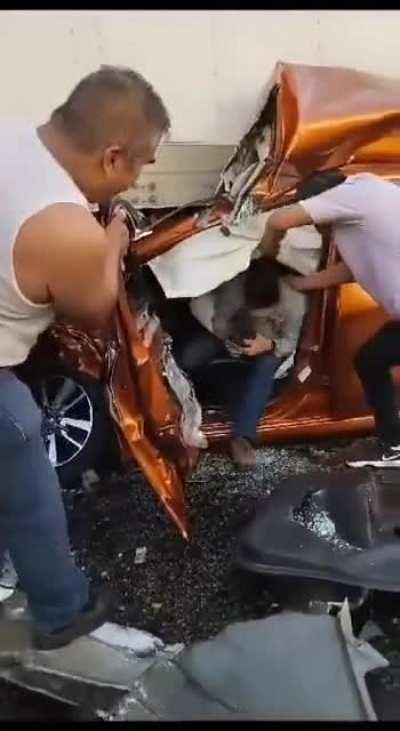 Airbags doing their thing helps driver step out of crushed car