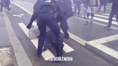 Cop being knocked out today during pension reform protests in Paris