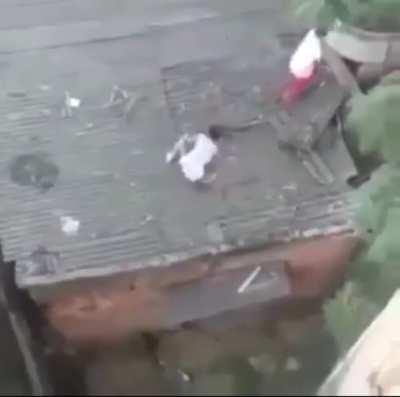 Three boyz were trying to catch a kite on top of the roof and look what happened