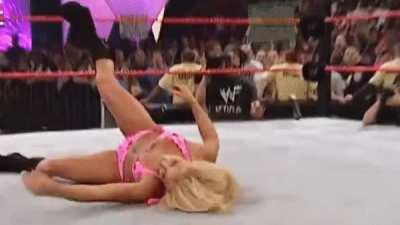 Trish in a bikini, gets hit in the head with a paddle