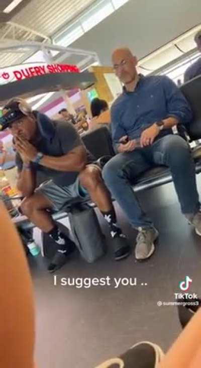 Bro gets upset when someone sits next to him at the airport terminal.