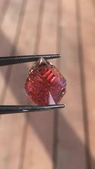 a dichroic 13 carat Oregon Sunstone that I cut recently in fantasy design... it displays a beautiful and bright red with some green on the edges... got to love Oregon Sunstone