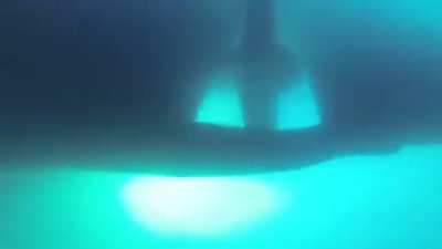 Camera captures how a large ship passes over a diver. Diver is fine.