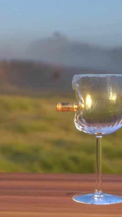 Bullet hitting a glas