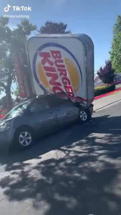 A Burger King sign crushed a car