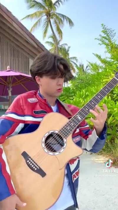 Overly Animated TikTok Guitarist Pretends to Play Pre Recorded Song Live