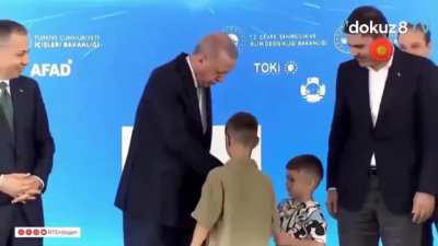 Caliph Erdogan slaps a child for not immediately kissing His Holiness' hand