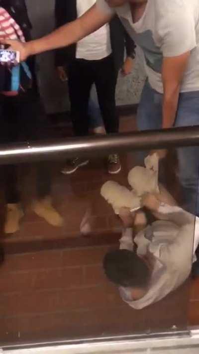 Robber gets wedgied, kicked and stomped while police stand there and spectate.