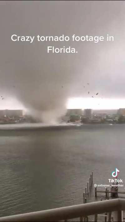 Awesome video of a water spout/tornado doing damage. The camera man stayed steady and doesn’t leave. Great footage.