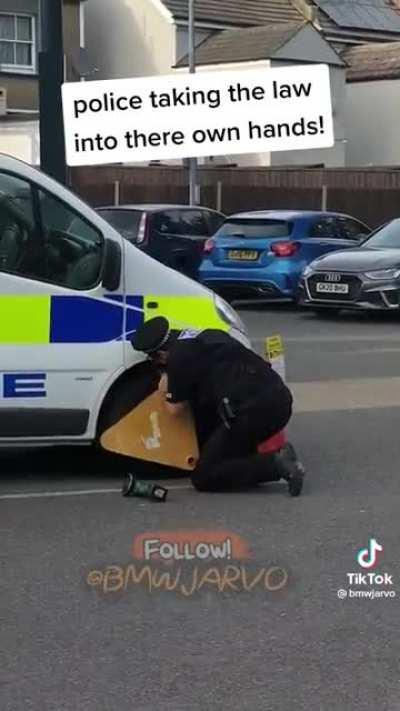 Someone clamped a Police vans wheel, the officer was not impressed and got to work sawing it off.