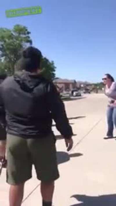 Two guys trying to fight a wrestler