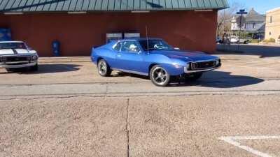 2 AMC Javalins and a Rambler leaving the meet